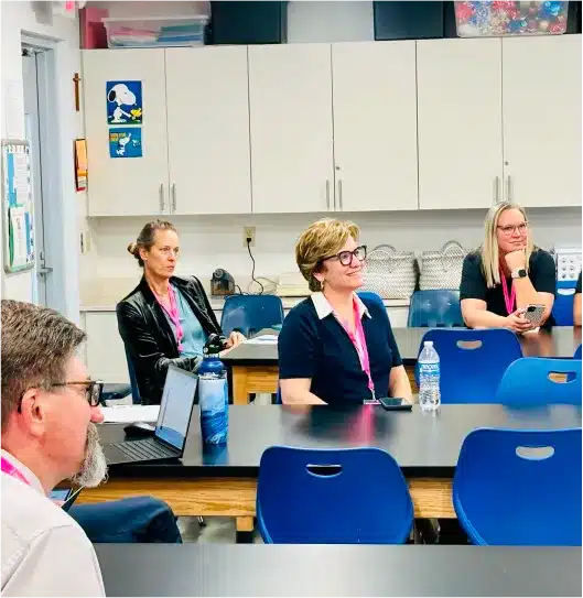 Group of educators seated at classroom tables during an i-Tech technology training session